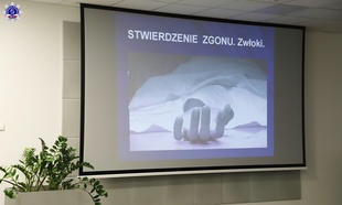 Ekran na którym wyświetlana jest prezentacja multimedialna „Stwierdzenie zgonu. Zwłoki”